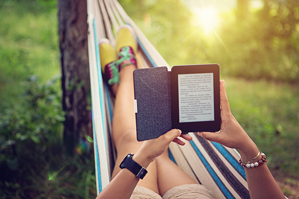 Person reading e-book in a hammock