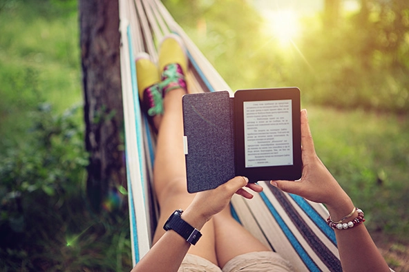 Person reading e-book in a hammock