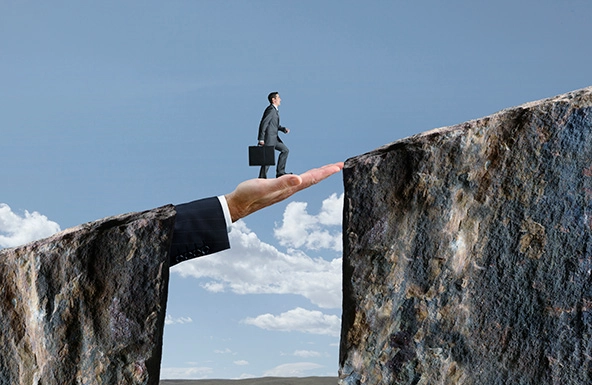 man walking on an outstretched hand up a slope