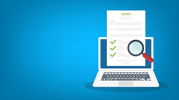 laptop, paper checklist, and magnifying glass