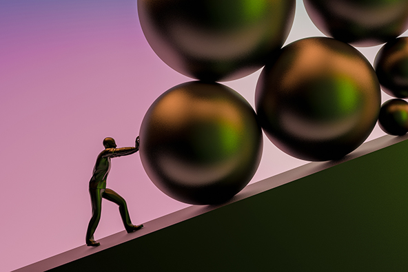 [silhouette of man pushing large round stones up a slope]

