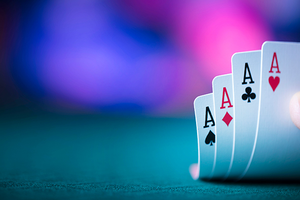 Hand holding four aces