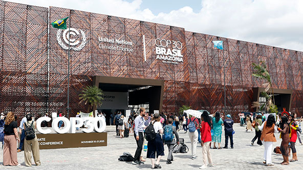 people walking outside of a building at COP30