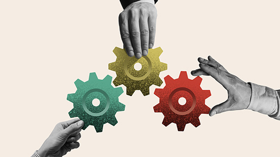 hands holding three gears together