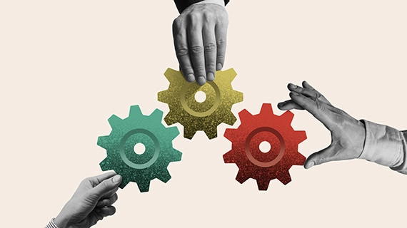 hands holding three gears together