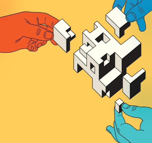 Hands putting together geometric shapes to form a cube