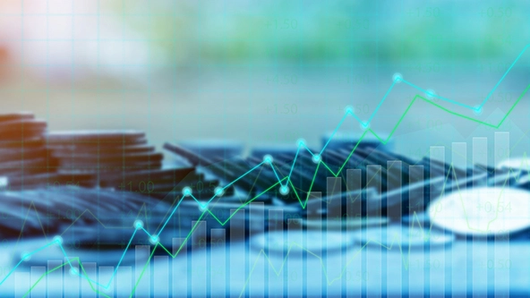 Coins in background; financial chart overlay