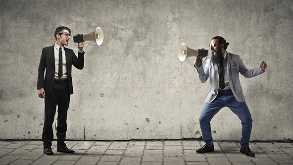 Two man are screaming with each other with megaphones in their hands