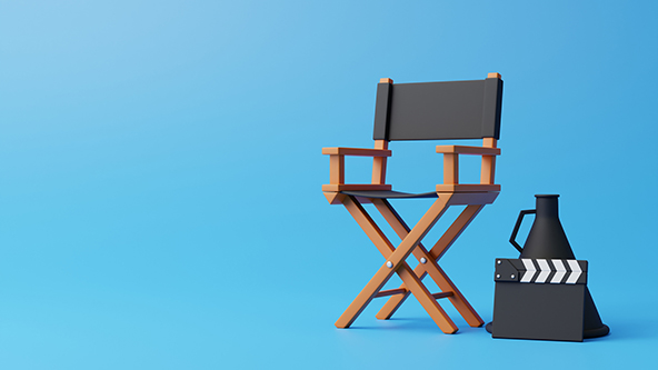 director chair, clapperboard and megaphone on blue background