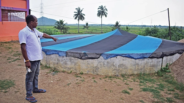 Man points to a covered well