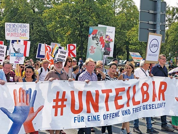 People behind a banner that reads 