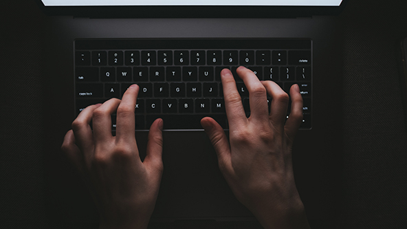 Overhead view of woman typing on a laptop