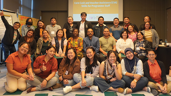 Group photo of CARE partners at a staff training