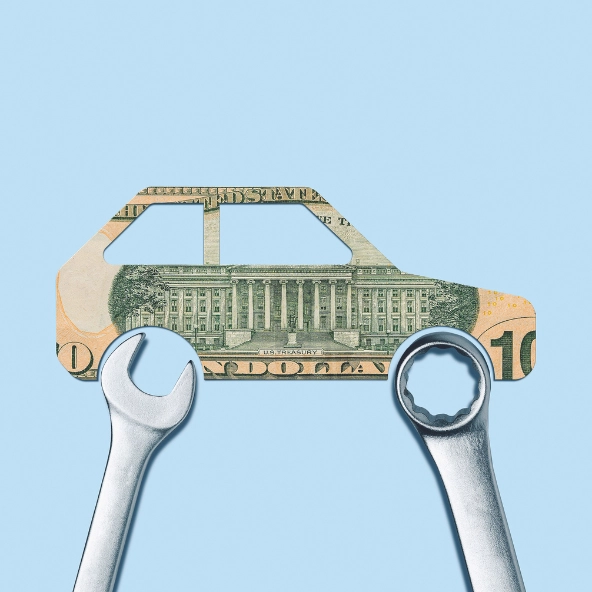 car made of a ten dollar bill with wrenches over the wheels
