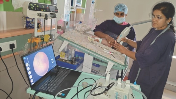 doctor using medical device to screen a baby in a medical care room in India