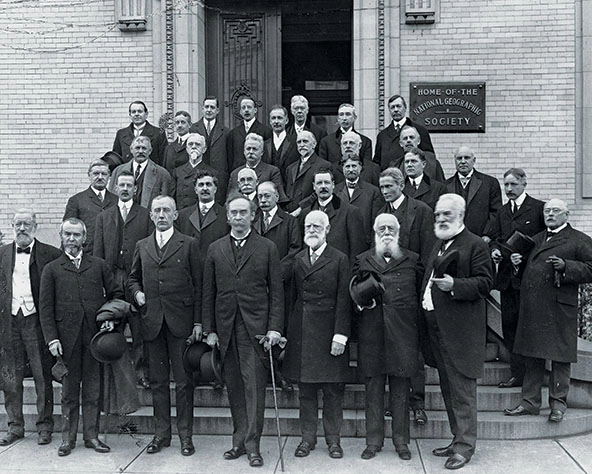 A black and white photo of men in suits and ties.