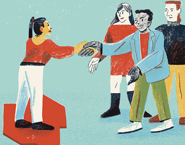 One person reaches out from a group to shake another person's hand
