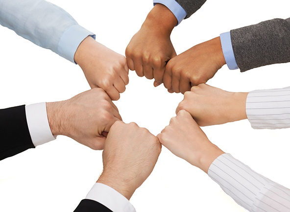 Closeup of hands in fists in circle 